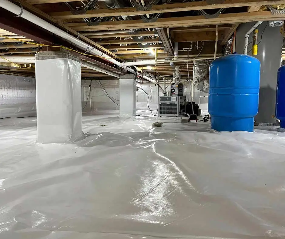 Crawl space encapsulation featuring blue water tanks and a sump pump installation, showcasing a clean and moisture-resistant environment in a Philadelphia home.